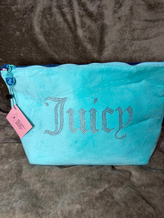 This is a Juicy Couture velour cosmetic bag in a light blue/turquoise color with a rhinestone